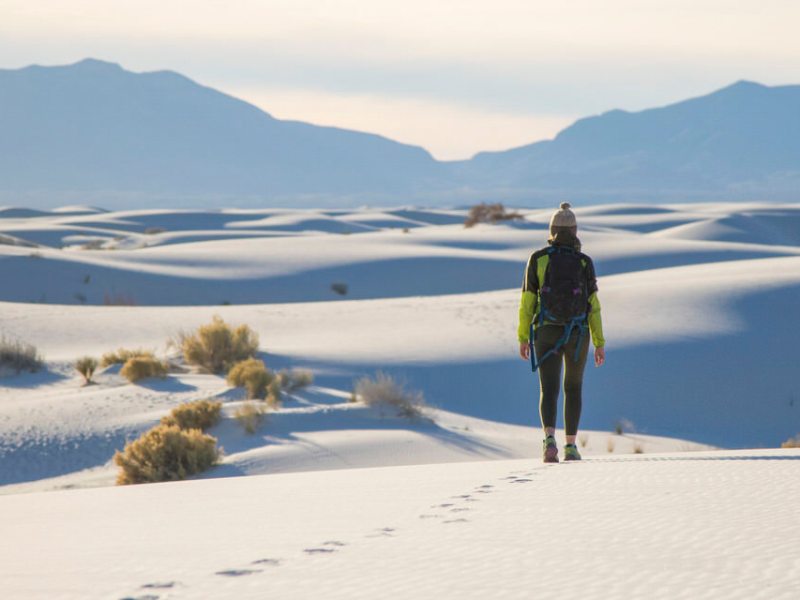 a person standing on top of a snow covered mountain