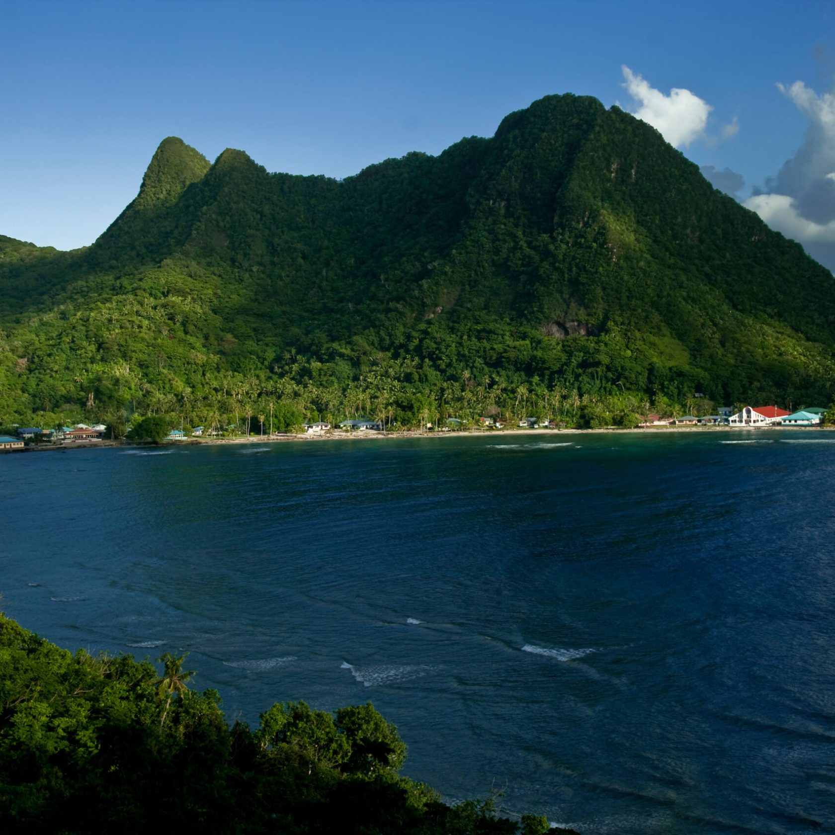a large body of water with a mountain in the background