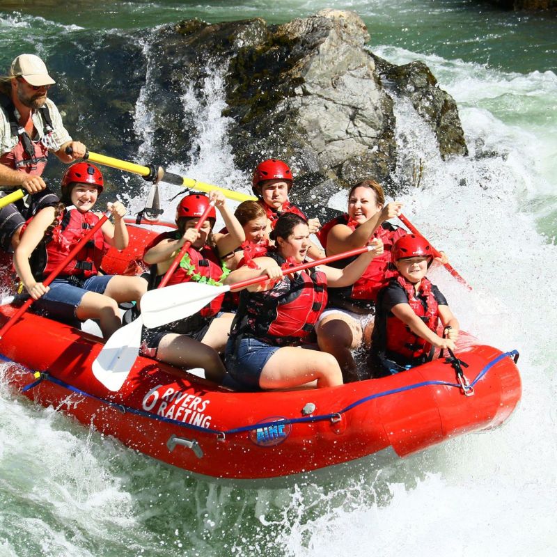 a group of people riding on a raft in a body of water