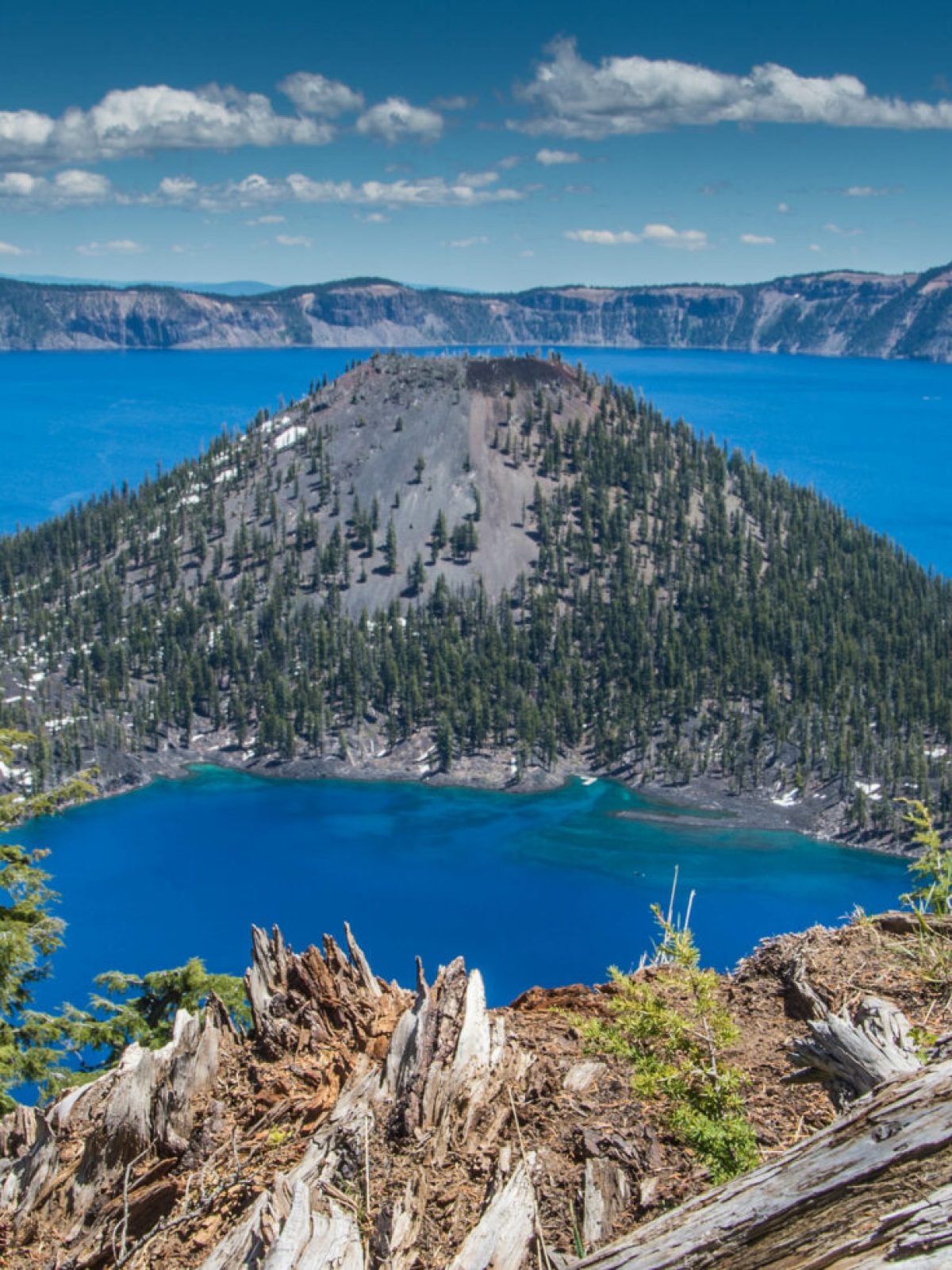 a body of water with Crater Lake National Park in the background