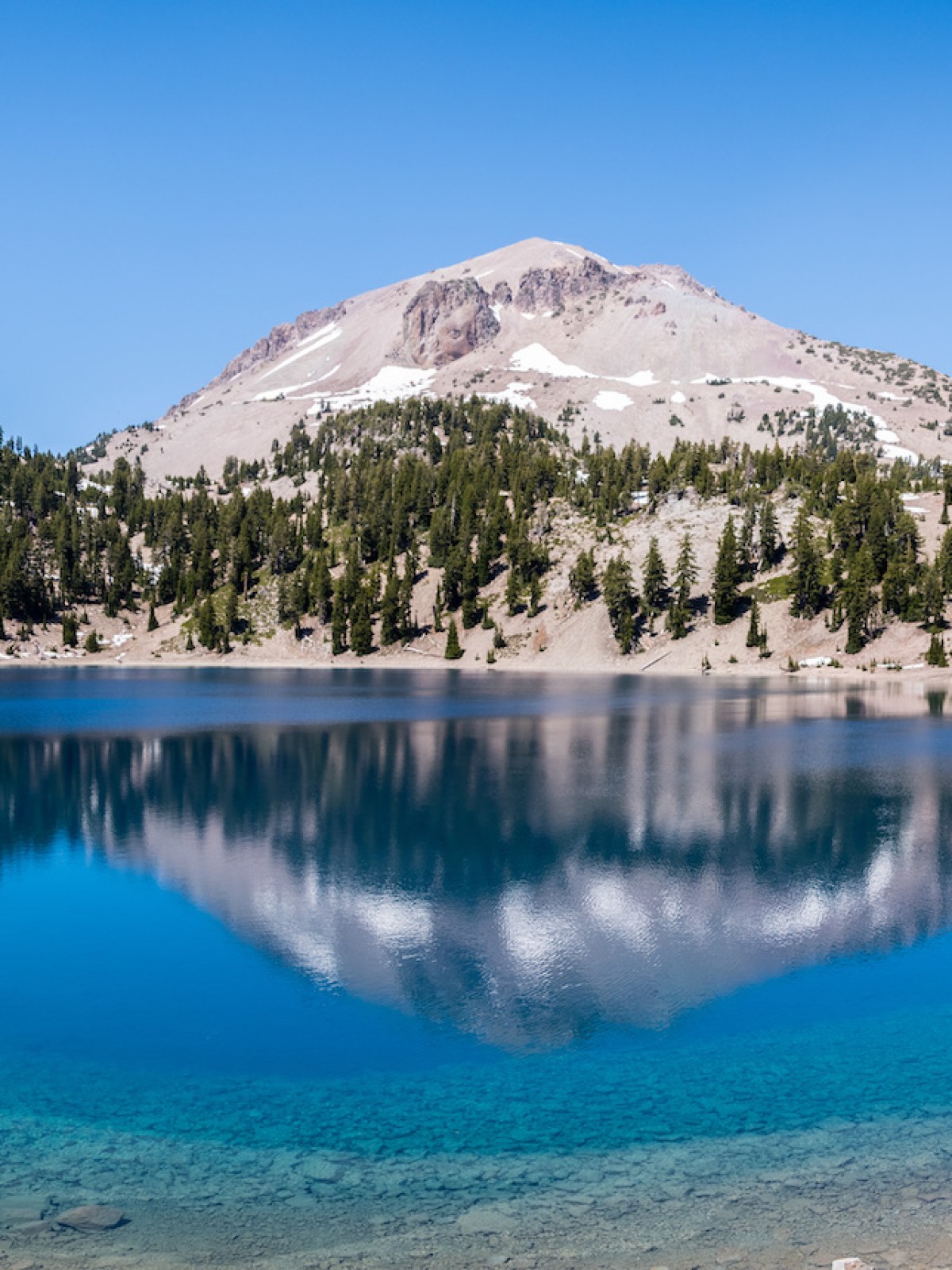 a body of water with a mountain in the background