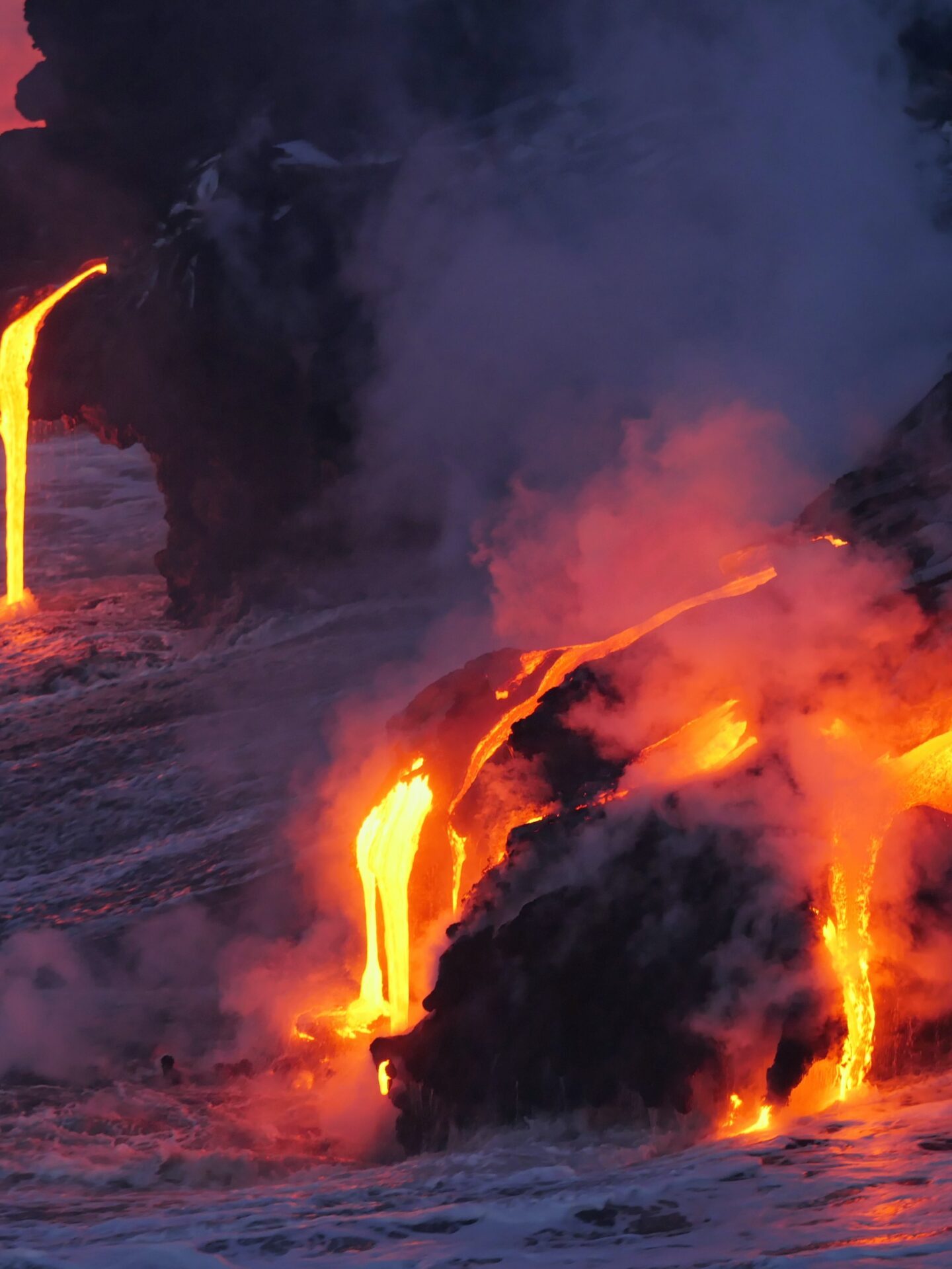 a train on a track with smoke coming out of a fire